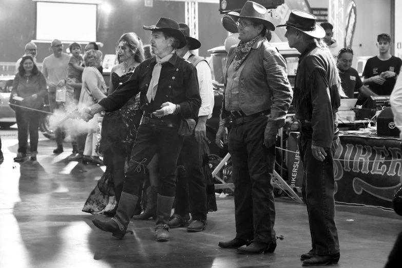 black and white pograph of people in cowboy hats