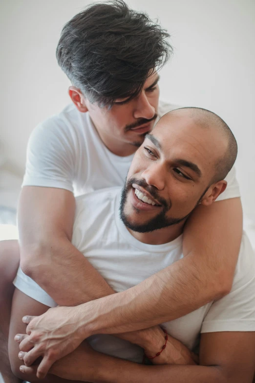 two men are hugging and smiling for the camera