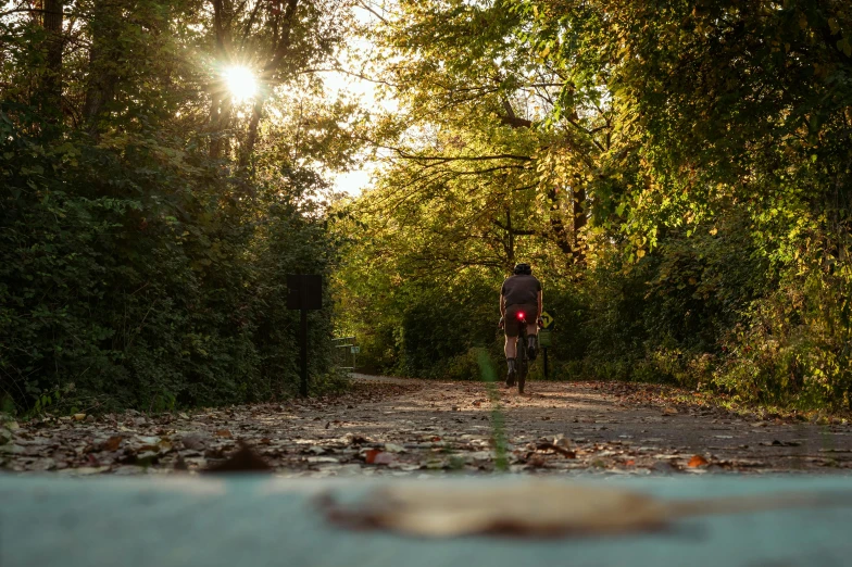 the man is riding a bike down the road