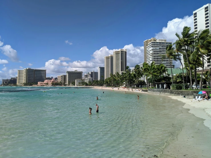 a beach that is filled with people on it