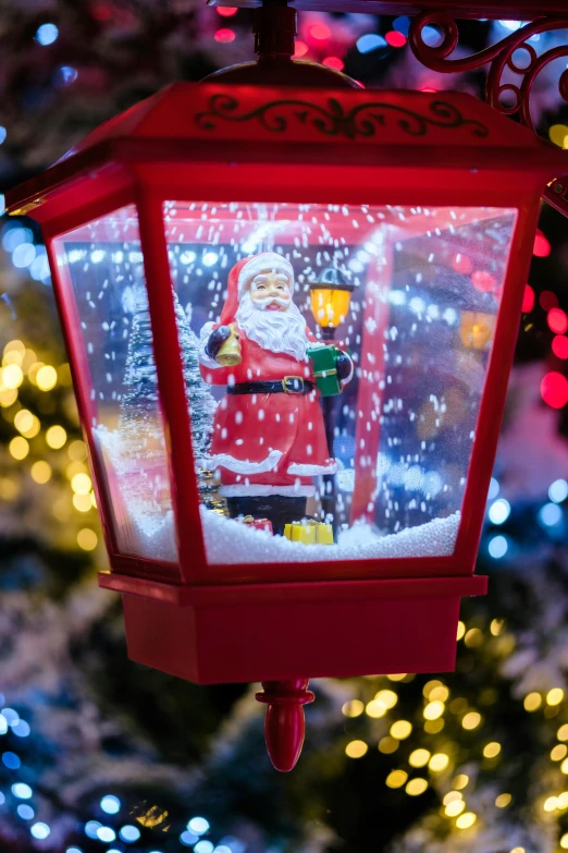 a red lit christmas decoration is shown in a snow scene