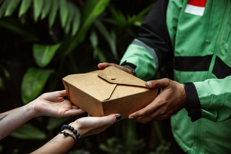 people exchanging an open gift box from another man