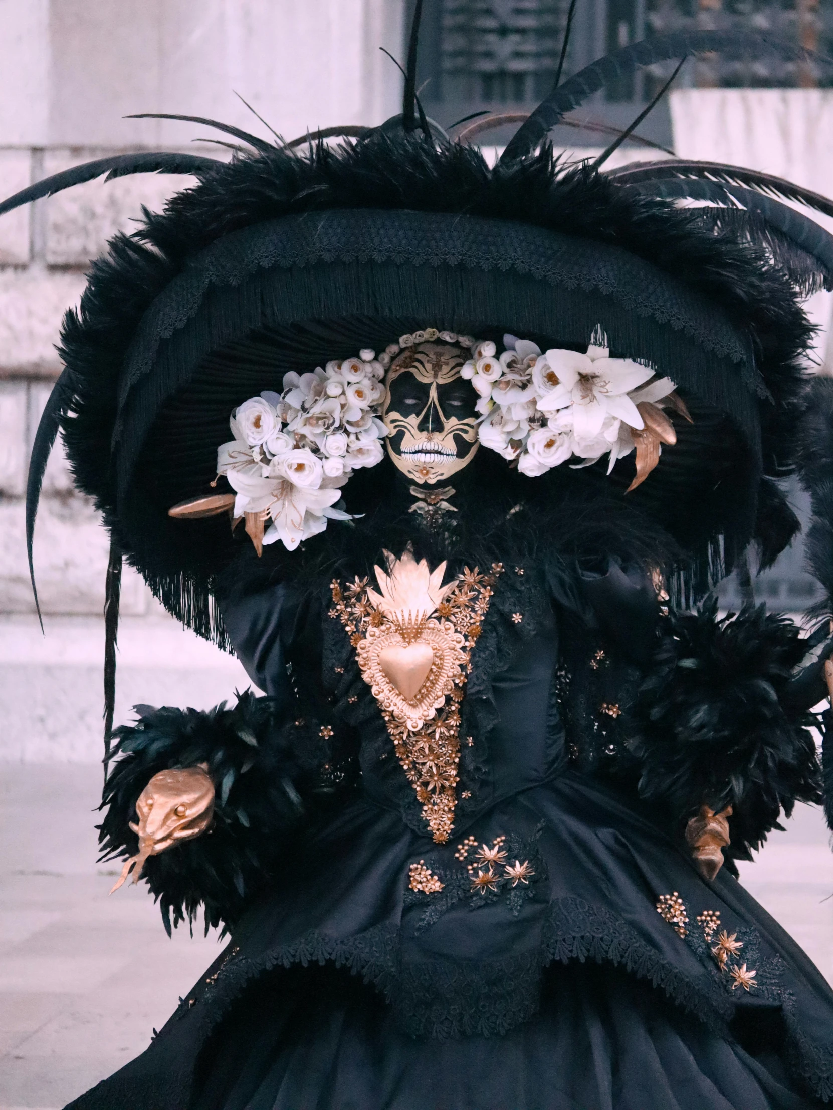 black clothing with gold details and flowers on a person