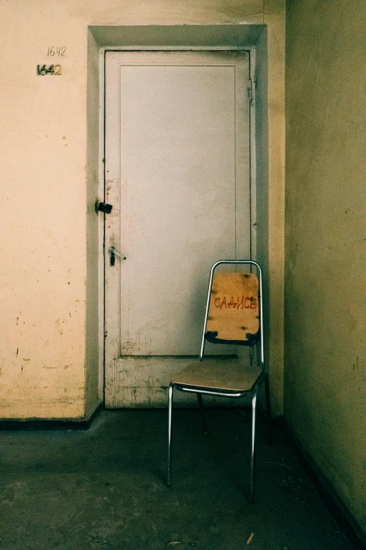 a chair with a back sits in a corner