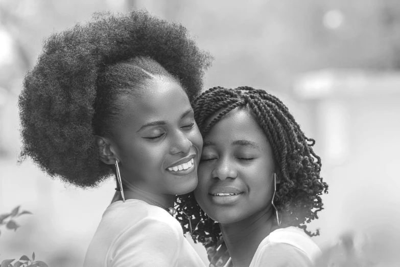 two young women hugging each other on the same day