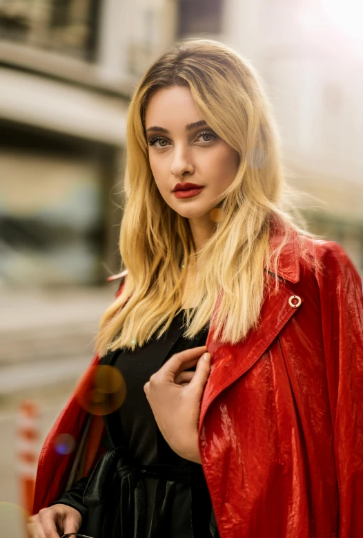 a woman in black dress and red leather jacket