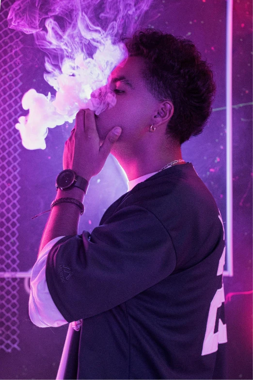 woman smokes in a dark room with purple lighting