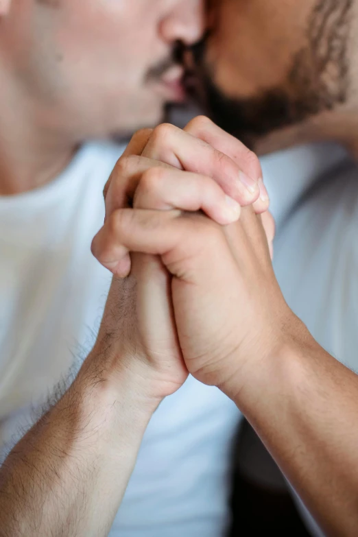 two males holding hands and a man looking over his shoulder