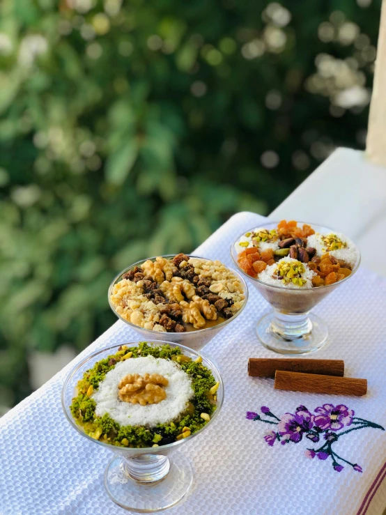 four dishes of different kinds of food sitting on a table