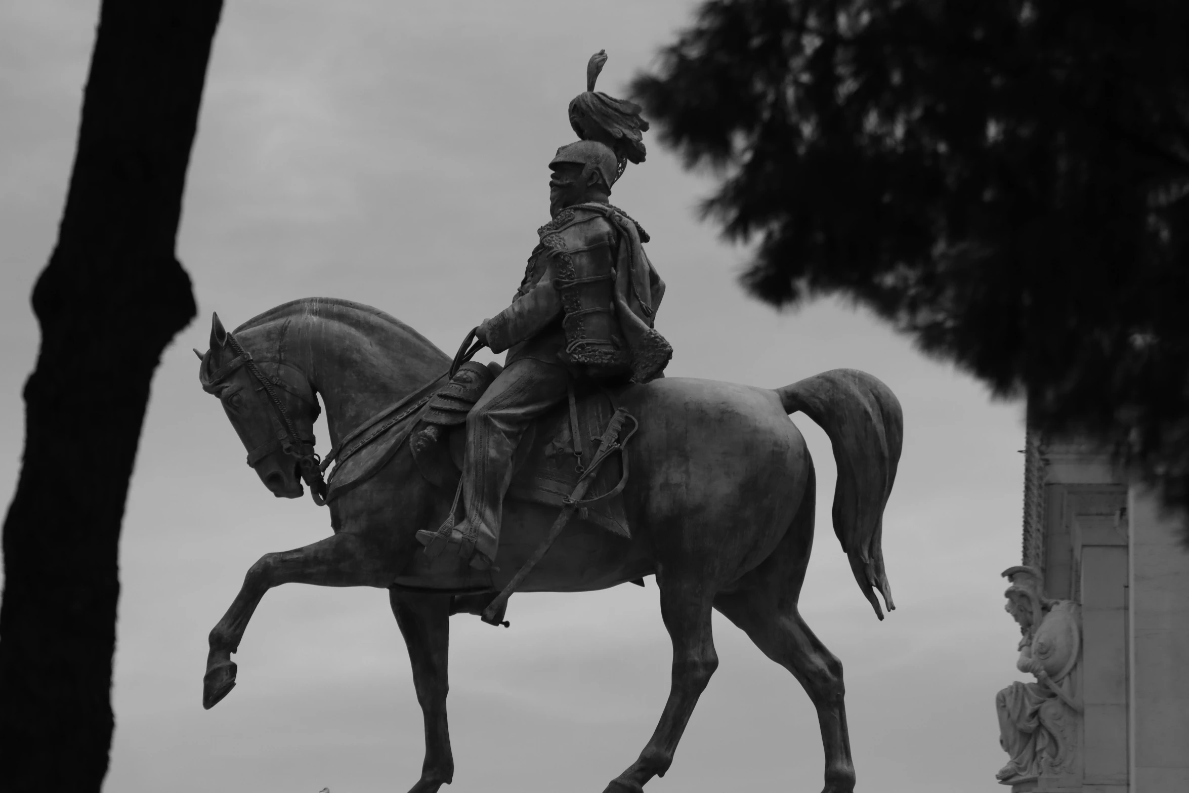 a black and white po of a statue of a man riding on a horse