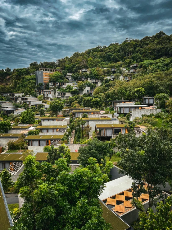 an area of houses sit on a mountain near the town