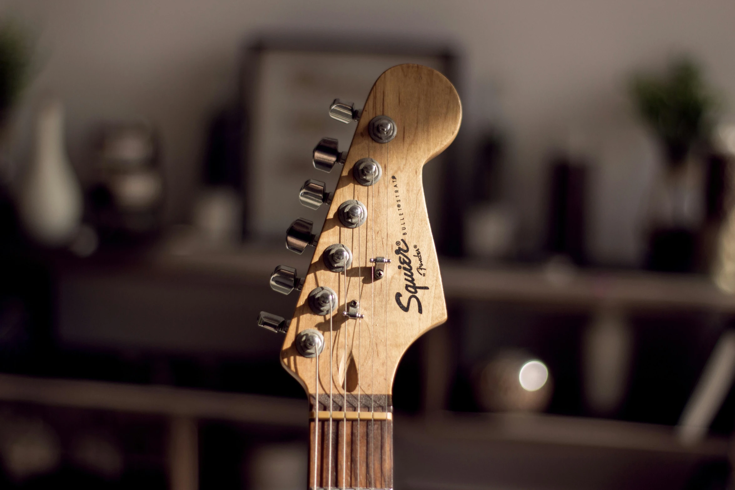 an electric guitar in a living room with its neck covered