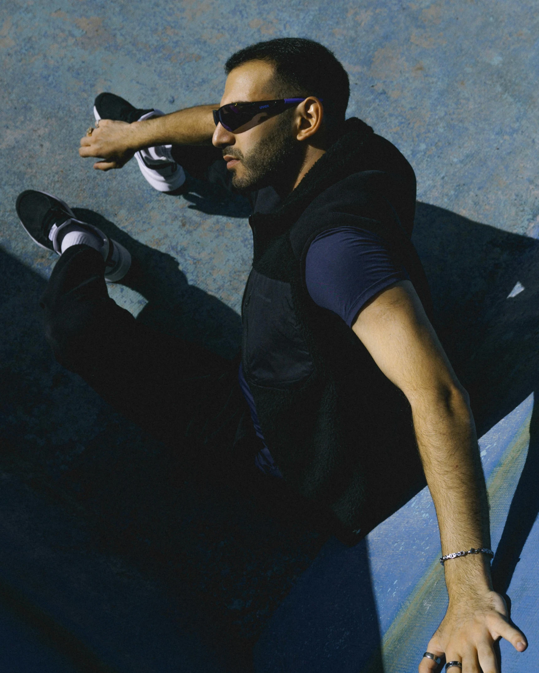 a man sitting down with his skateboard at his feet