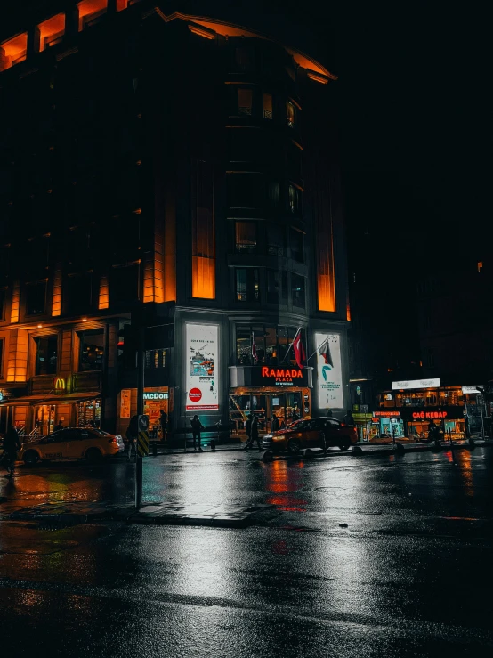 a nighttime scene with a bus and some buildings