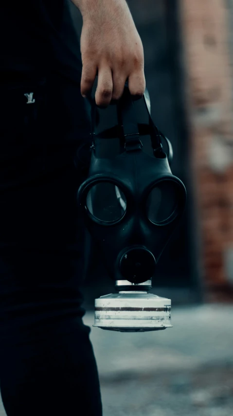 a person with a gas mask on holding a device