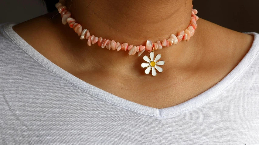 a necklace with flower pendant hanging from it