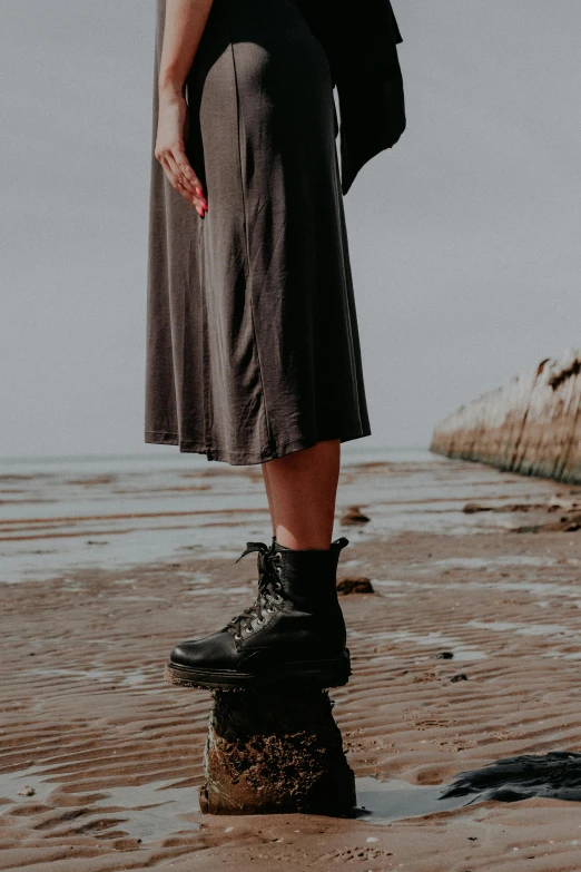 a woman standing with her shoes up on top of an object