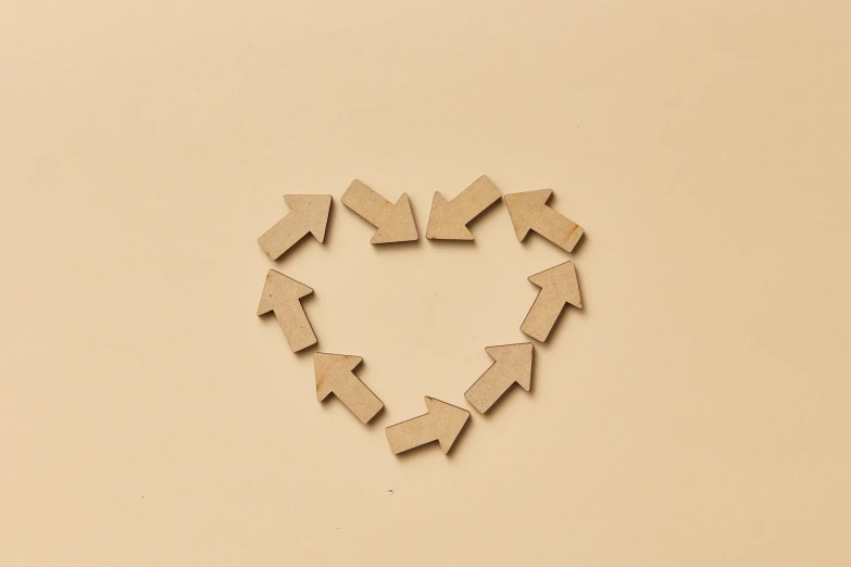 a wooden heart with many arrows around it
