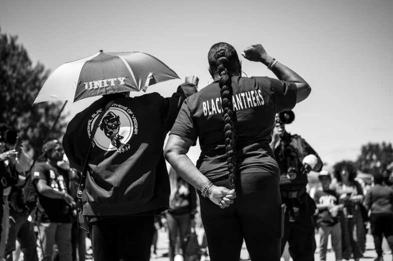 two people standing underneath an umbrella in the rain