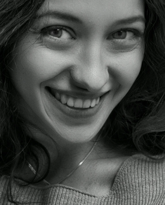 a black and white po of a woman with a smile on her face