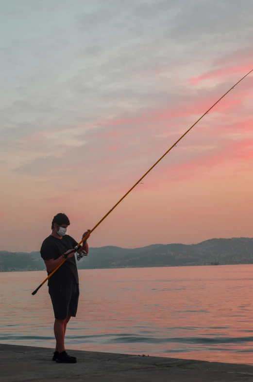 a person holding onto a fishing pole with a rod