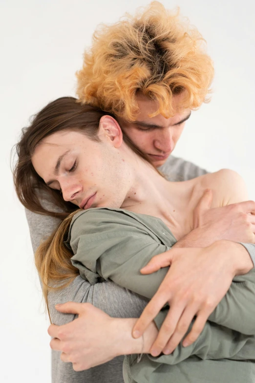 two people hugging each other in a white background