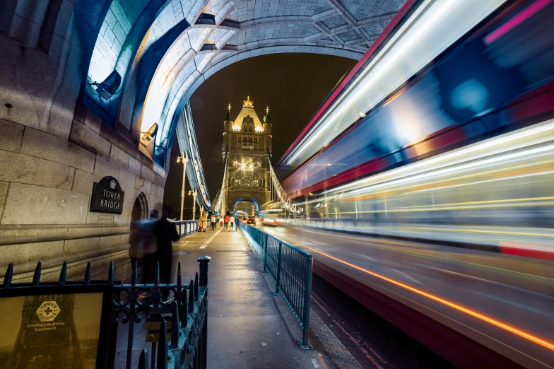 the light trails underneath the old bridge in england