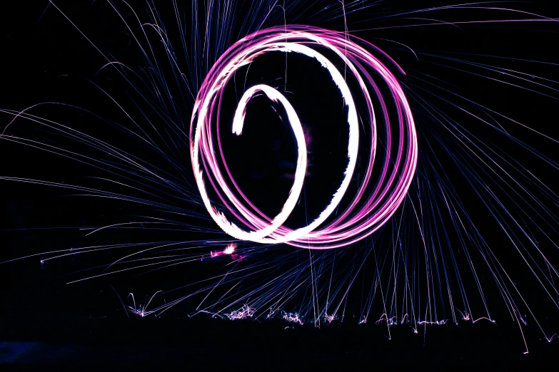 a colorful circle that is on top of a pole