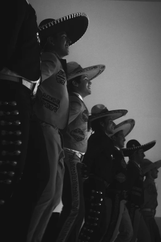 black and white pograph of people sitting in hats