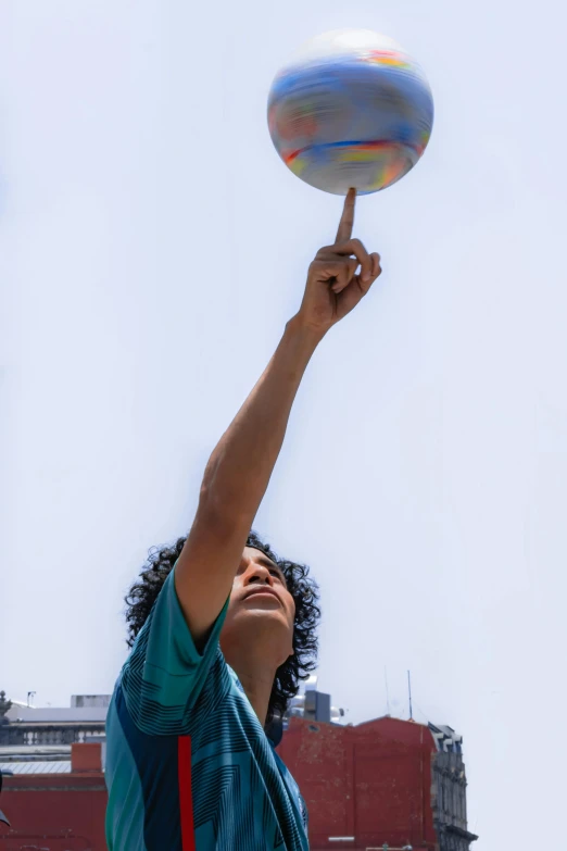 a young man holding up a ball in the air