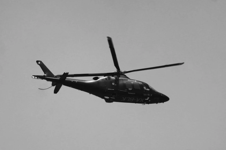 a helicopter flying in the sky during the day