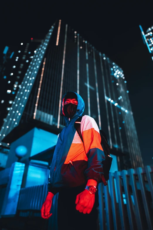 a man in a safety jacket and reflective clothing standing in front of some tall buildings
