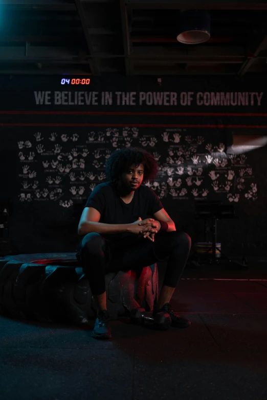 a woman in a black shirt with an afro haircut