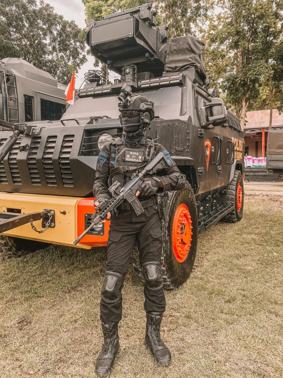 a man dressed as a military man standing next to a large armored vehicle