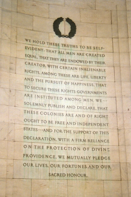 a monument features several words on a large stone