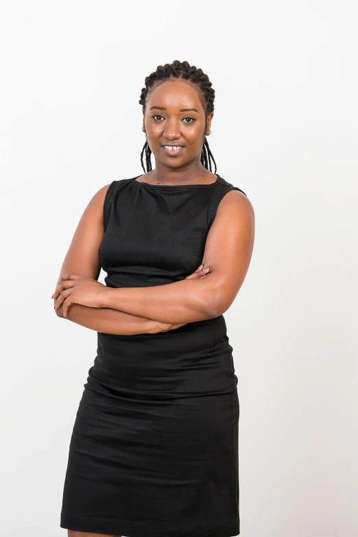 a woman posing for a picture, with her arms crossed