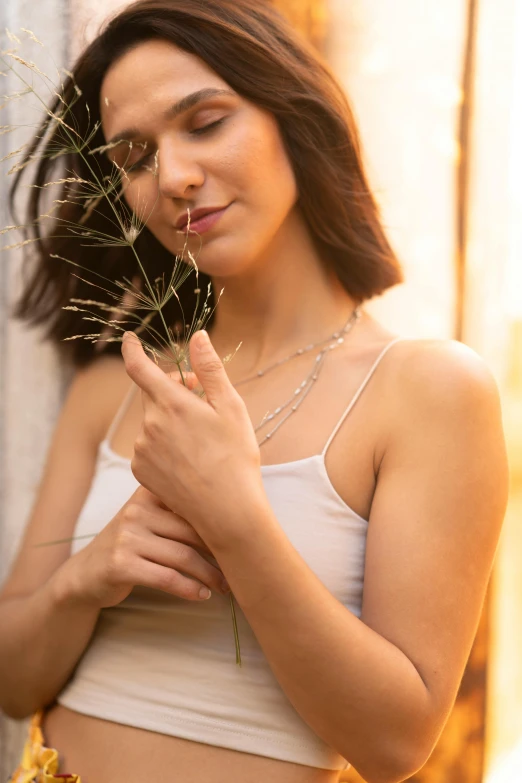 a woman with her hands around a flower