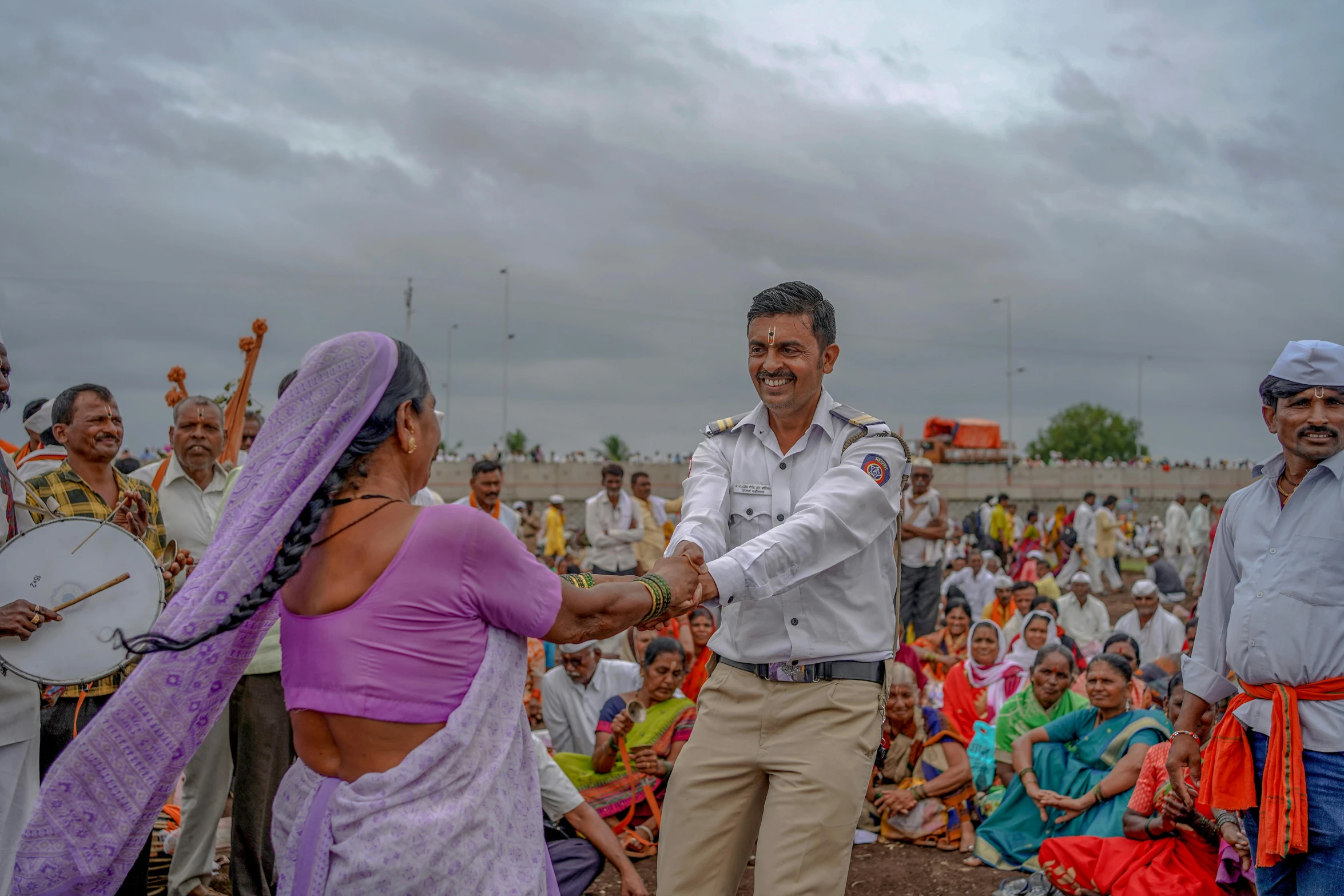 two men shake hands at an event