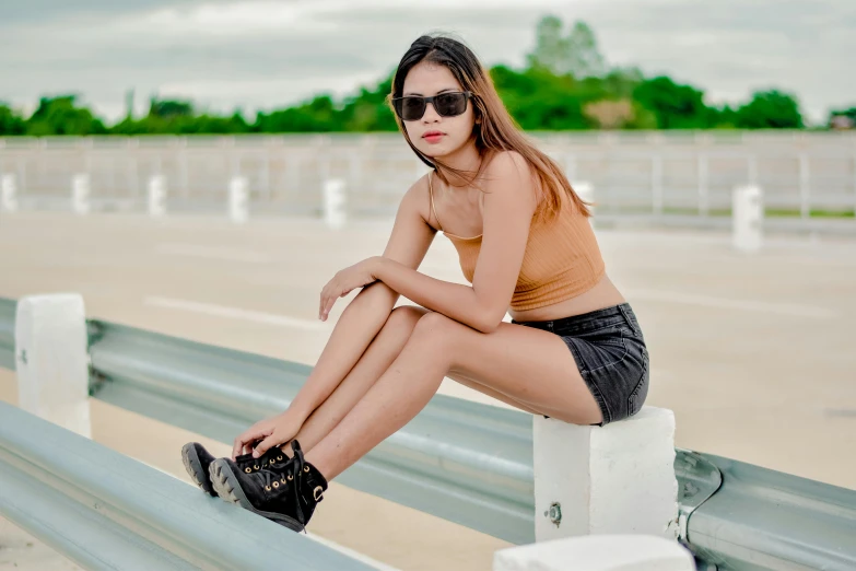 young woman with sunglasses on leaning on rail