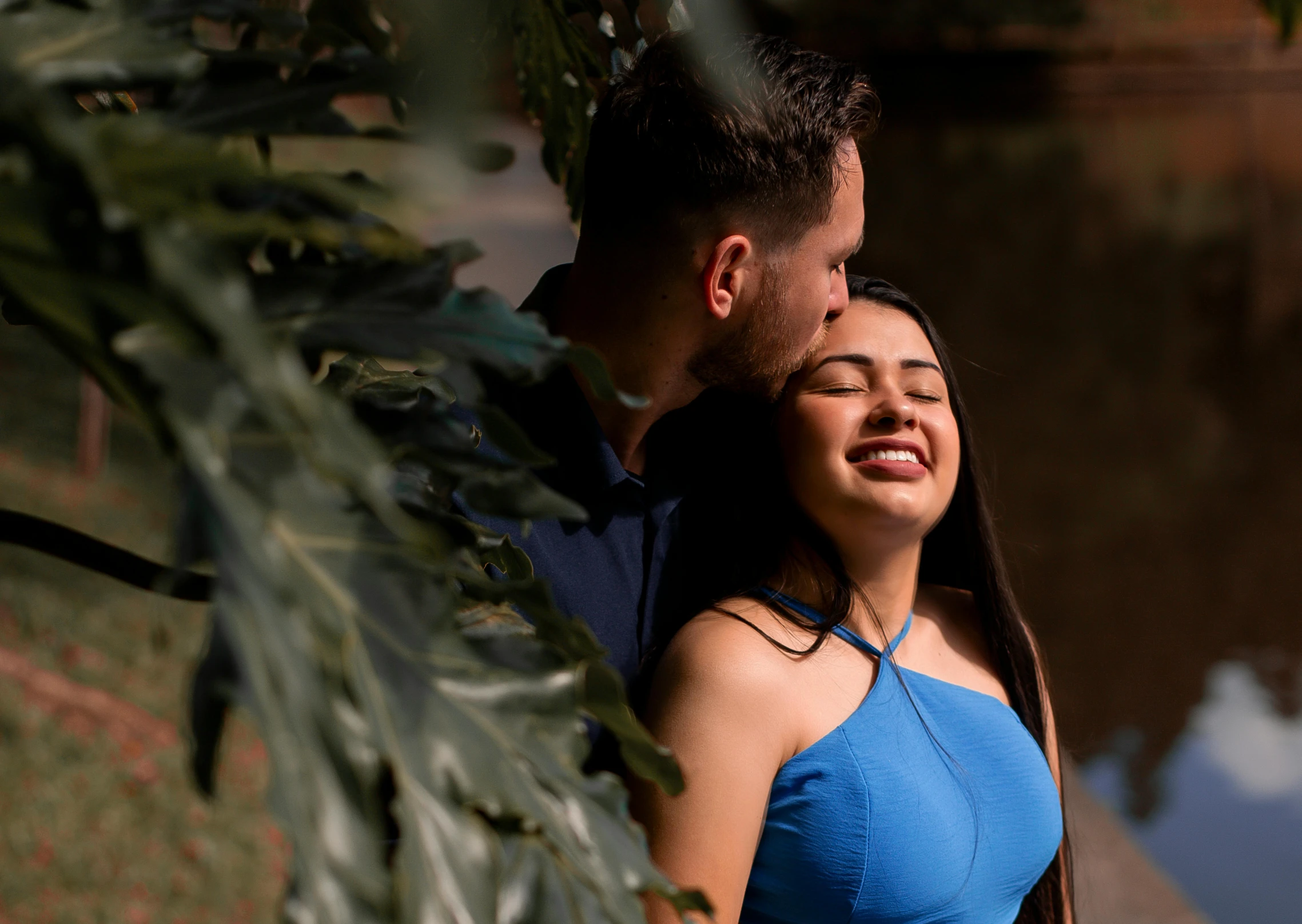 the man is hugging the woman in front of her