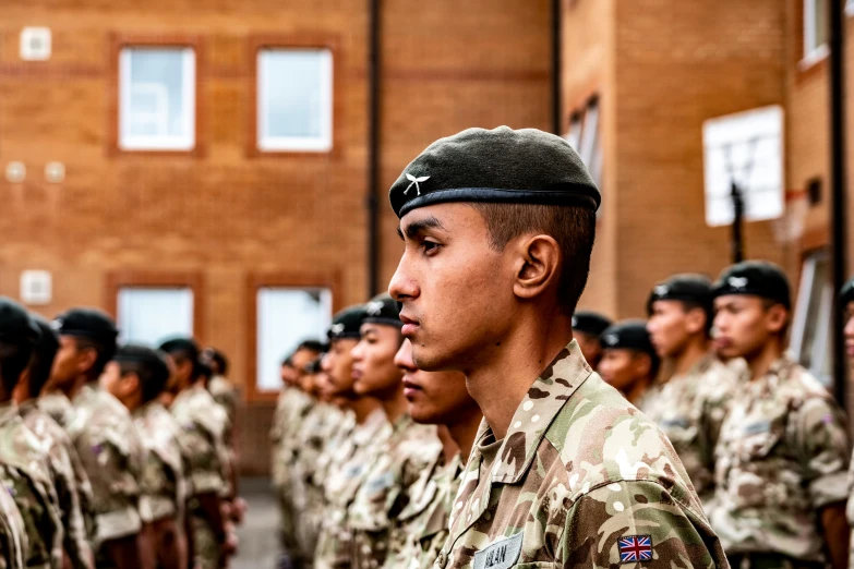 a group of military men standing in front of an army building