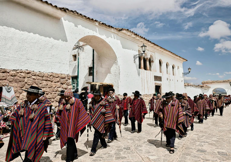 a group of people in hats walking across a street