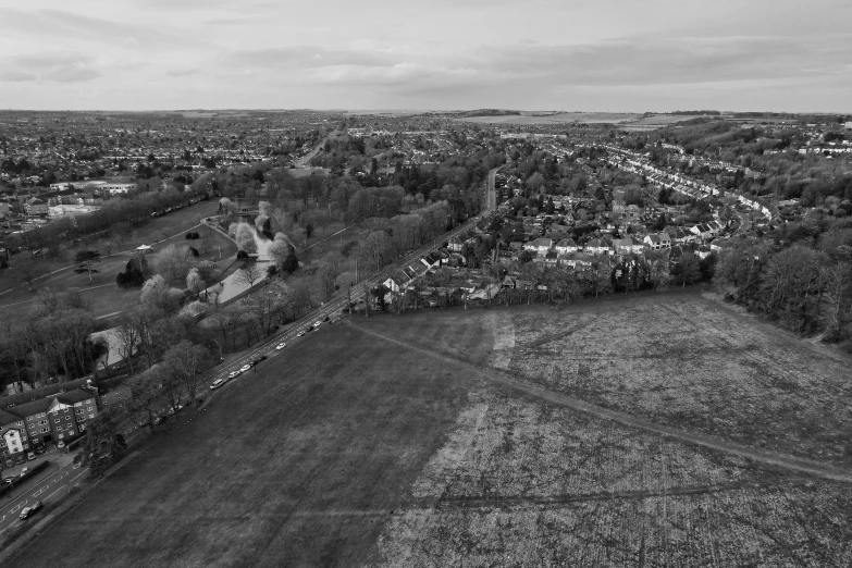 an aerial view of a field with lots of grass and trees