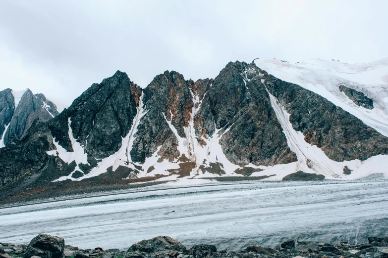 a large mountain is covered with white snow