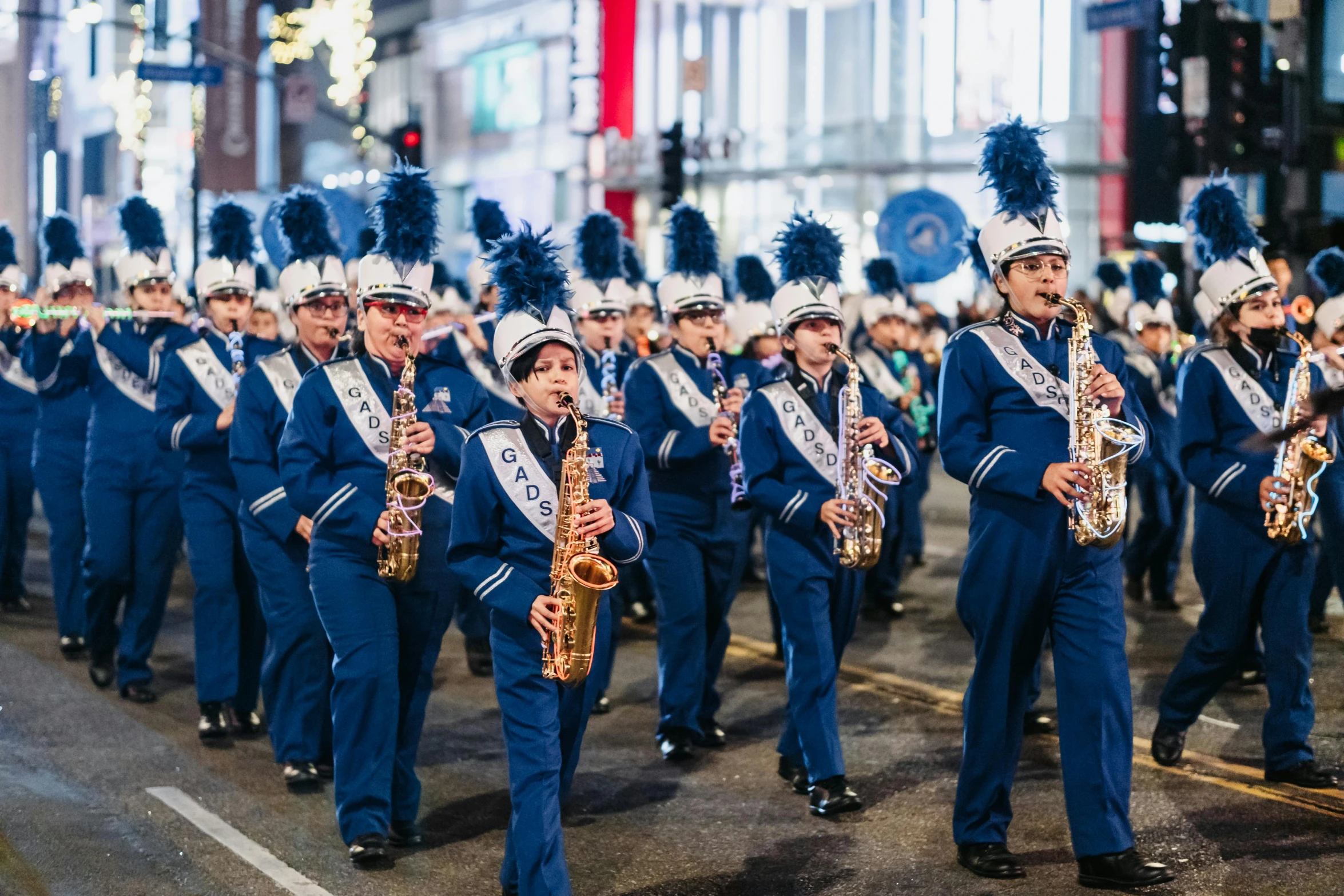 a parade with people marching down the street