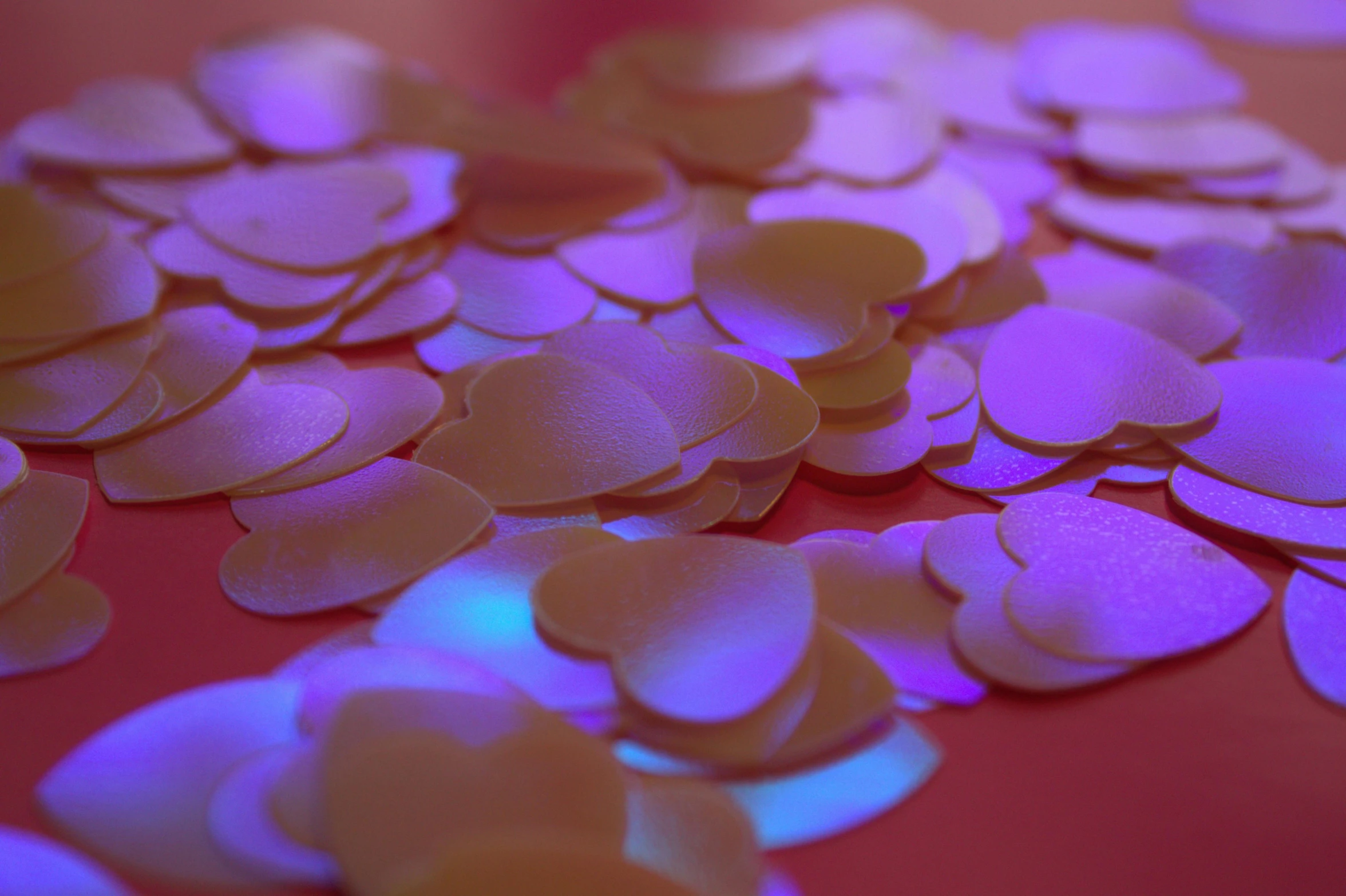 small confetti like shapes with light up blue and pink