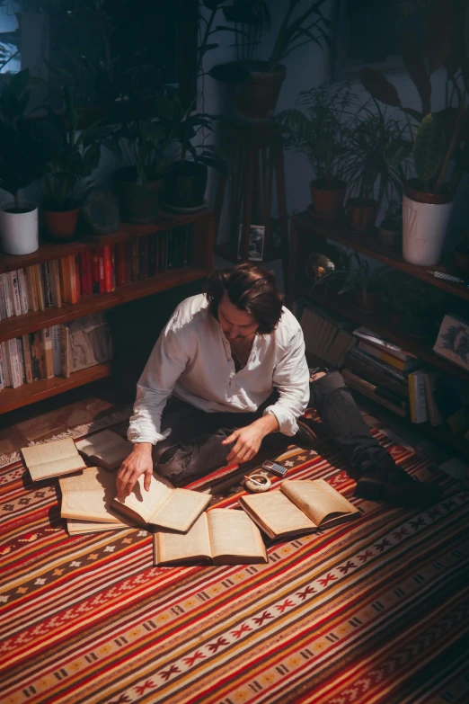 man working on rug with scissors in a home