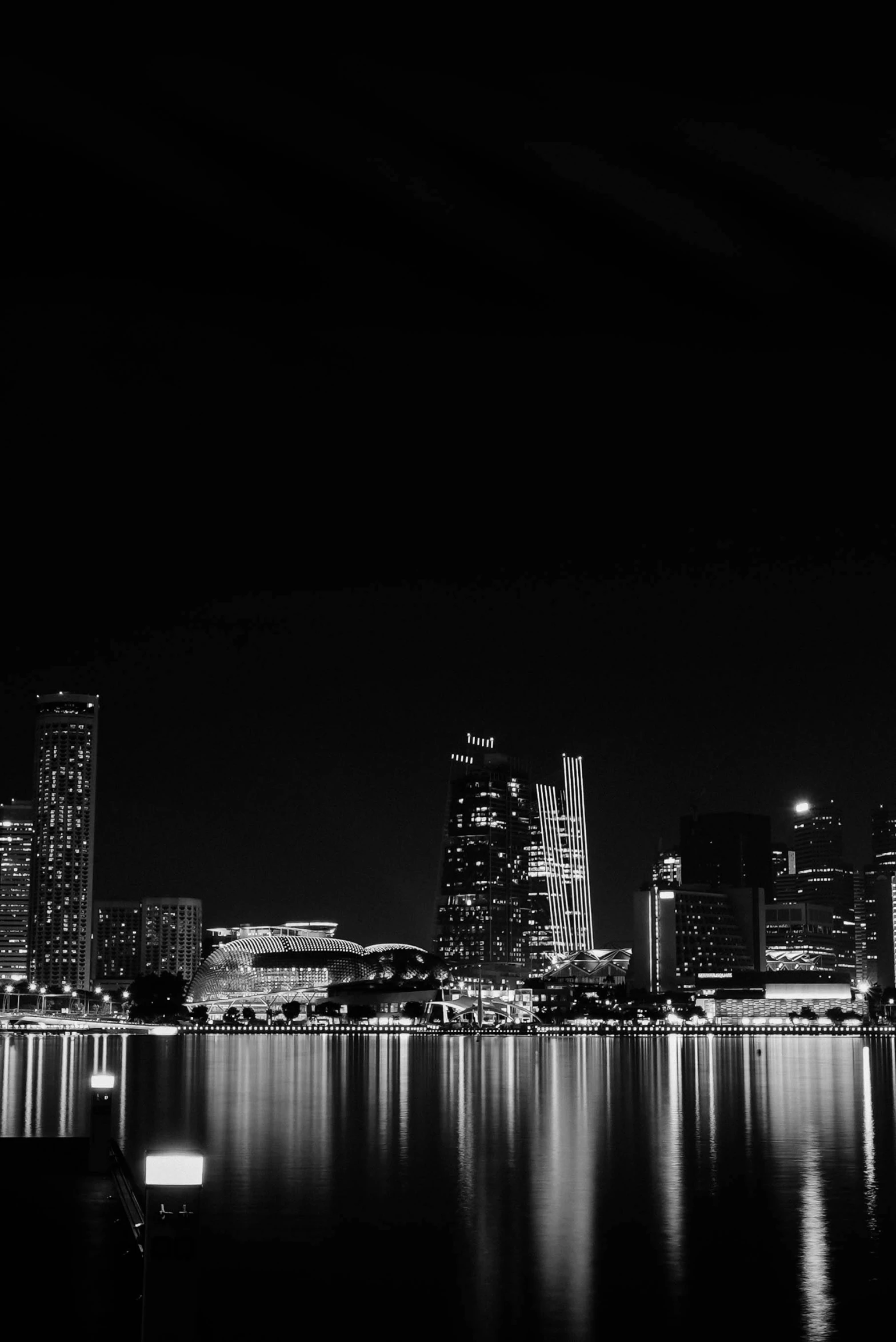 black and white po of city lights from across the bay