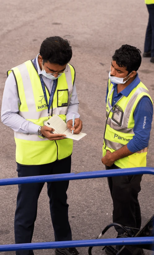 two men are standing with safety equipment