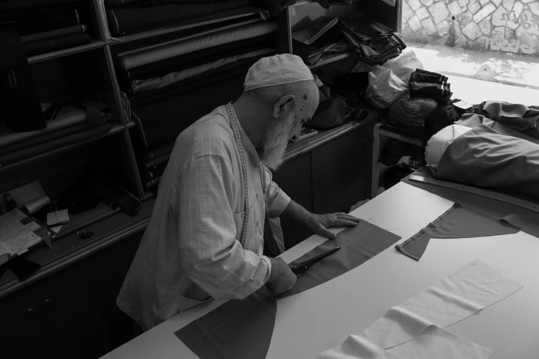 a man is making paper in a studio